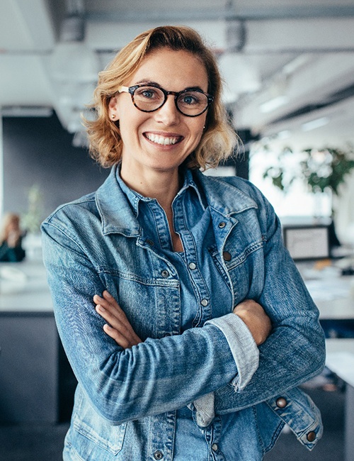 A woman smiling with greater confidence at work