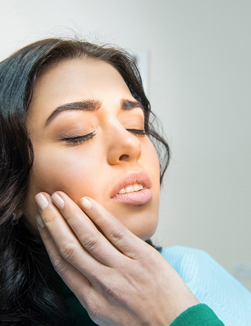 Woman dealing with discomfort in treatment chair