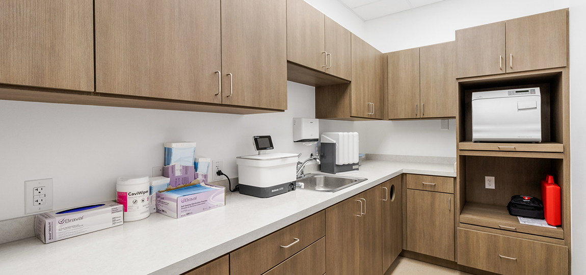 Cabinets and counter with sink in dental office
