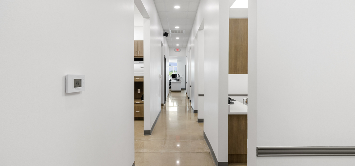 Hallway in dental office with doorways leading to treatment areas
